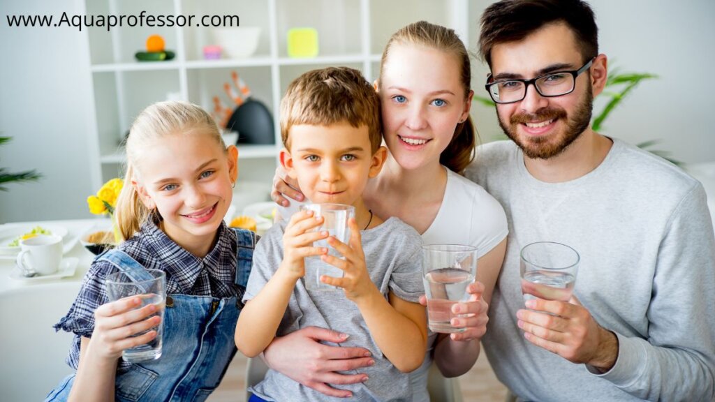 a family of a man, woman and two kids drinking water 